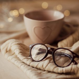 Eyeglasses with mug on warm scarf