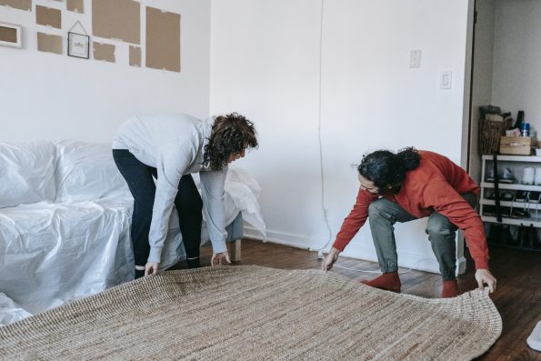 Couple moving out a carpet